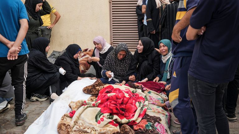 Palestinians mourn relatives killed in an Israeli strike on a U.N.-run school in the Nuseirat refugee camp. Pic: AP