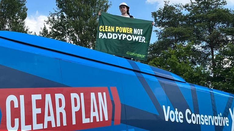 Amy Rugg-Easey on top of the Conservative election campaign bus in Nottinghamshire on Wednesday. Pic: PA