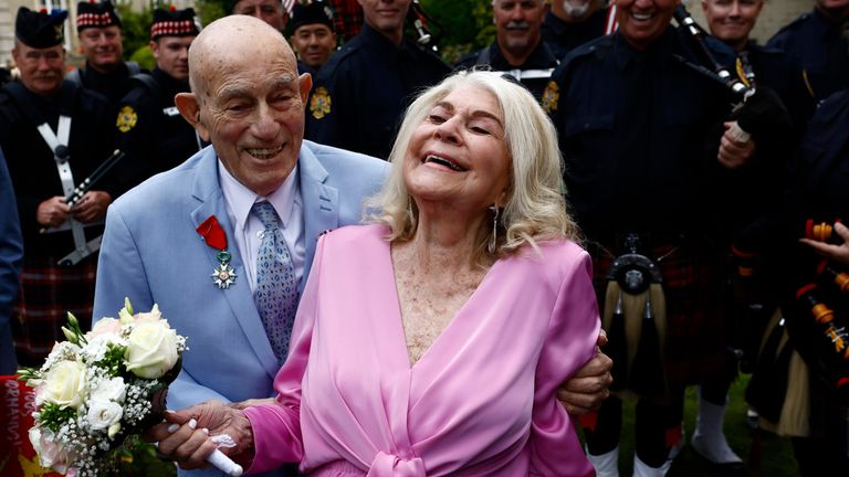 American World War II veteran Harold Terens, 100, left, and Jeanne Swerlin, 96, arrive to celebrate their wedding at Carentan-les-Marais town hall in Normandy, northwest France, on Saturday, June 8 2024. Together, the collective age of the bride and groom was almost 200 years old.  But Terens and his girlfriend Jeanne Swerlin proved that love is eternal when they tied the knot on Saturday inland on the D-Day beaches of Normandy, France.  (AP Photo/Jeremiah Gonzalez)