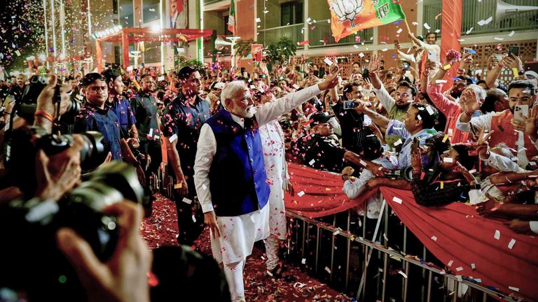 Prime Minister Narendra Modi is greeted by supporters as he arrives at Bharatiya Janata Party (BJP) headquarters in New Delhi, India, Tuesday, June 4, 2024. (AP Photo/Manish Swarup)
