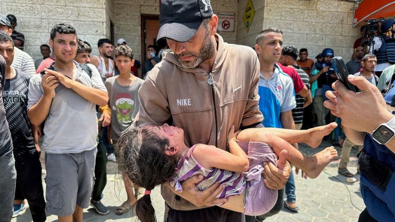 A man carries a casualty after an Israeli strike. Pic: Reuters