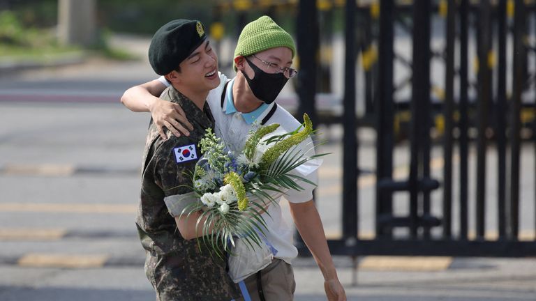 K-pop boy band BTS member Jin is greeted by a group member J-Hope after being discharged from the military in Yeoncheon, South Korea.
Pic: Reuters
Pic: Reuters