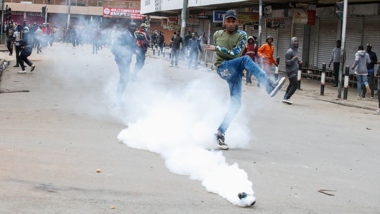 A man kicks a tear gas cannister at a demonstration over police killings of people protesting against Kenya's proposed finance bill 2024/2025, in Nairobi, Kenya, June 27, 2024. REUTERS/Monicah Mwangi