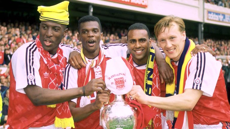 Kevin Campbell, Paul Davis, David Rocastle and Lee Dixon celebrate winning the championship.  Photo: Reuters
