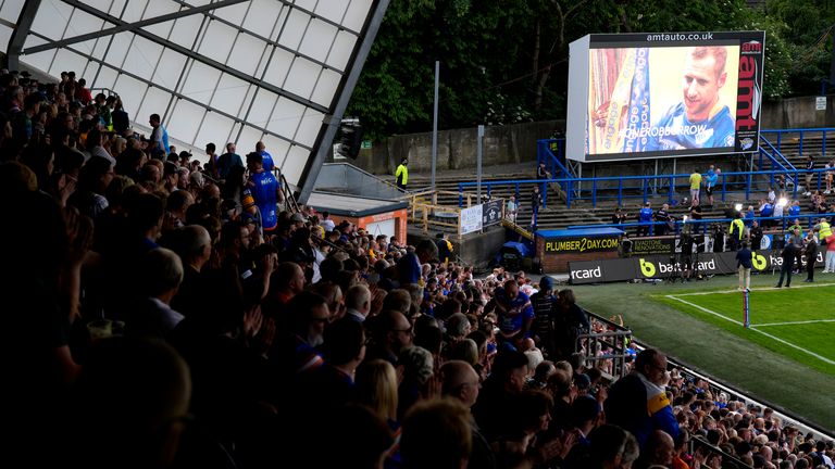 Leeds Rhinos fans watch Rob Burrow's tributes play on the big screen ahead of the Betfred Super League match at AMT Headingley Stadium, Leeds.  Photo date: Friday, June 21, 2024. Photo: PA