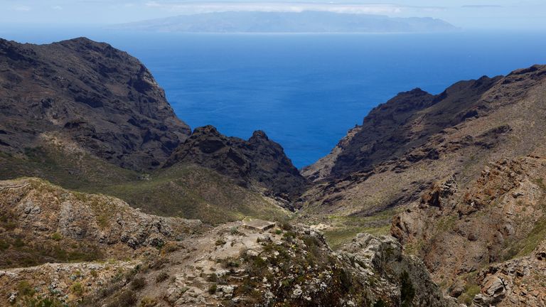 view of the Los Carrizales ravine where British teenager Jay Slater is being searched for, with the island of La Gomera in the distance, on the island of Tenerife, Spain, June 27, 2024. REUTERS/Borja Suarez