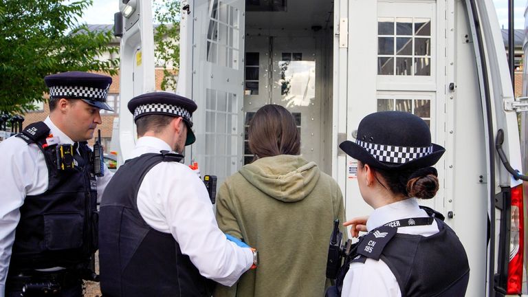 Officers making an arrest as part of the operation. Pic: Met Police