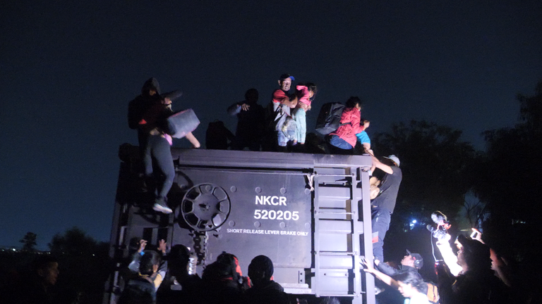 Ramsay mexico feature - irapuato - migrants loading onto the beast at night 1