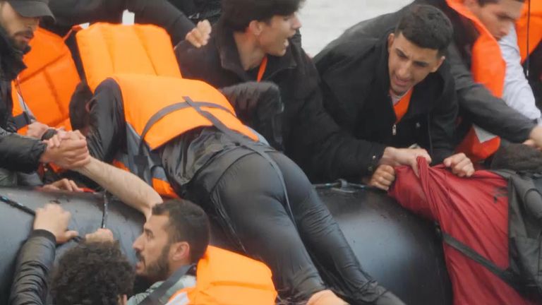 Migrants climb onto boat in Calais as police watch unable to intervene