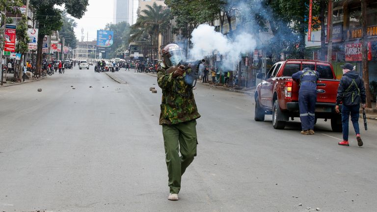 A police member fires tear gas at a demonstration over police killings of people protesting against Kenya's proposed finance bill 2024/2025, in Nairobi, Kenya, June 27, 2024. REUTERS/Monicah Mwangi