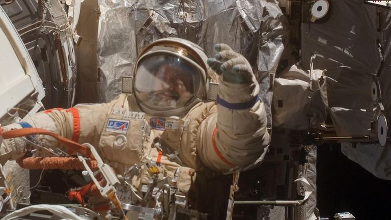 A cosmonaut helps install containers to collect microbes living in space. File pic: NASA