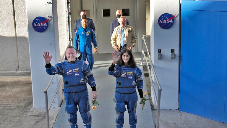 NASA astronauts Butch Wilmore, left, and Suni Williams waves to photographers after leaving the operations and checkout building for a trip to launch pad at Space Launch Complex 41 Wednesday, June 5, 2024, in Cape Canaveral, Fla. The two astronauts are scheduled to liftoff later today on the Boeing Starliner capsule for a trip to the international space station. . (AP Photo/Chris O’Meara)