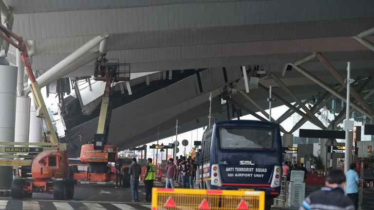 2024年6月28日金曜日、インドのニューデリーで、モンスーン前の豪雨により倒壊したニューデリーのインディラ・ガンジー国際空港で、出発ラウンジの天蓋の一部の損傷を検査する乗務員。(AP写真)