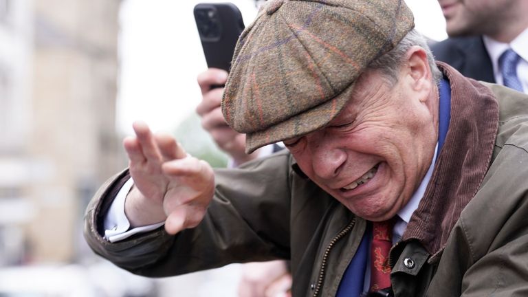 Nigel Farage reacts after something is thrown towards him on the Reform UK campaign bus.
Pic:PA
