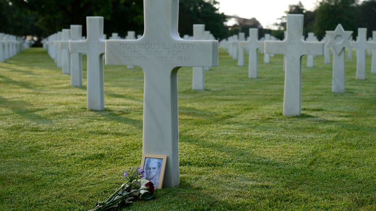Flowers are left on the grave of an American World War II soldier at the Normandy American Cemetery in Colleville-sur-Mer.  Photo: AP Photo/Virginia Mayo