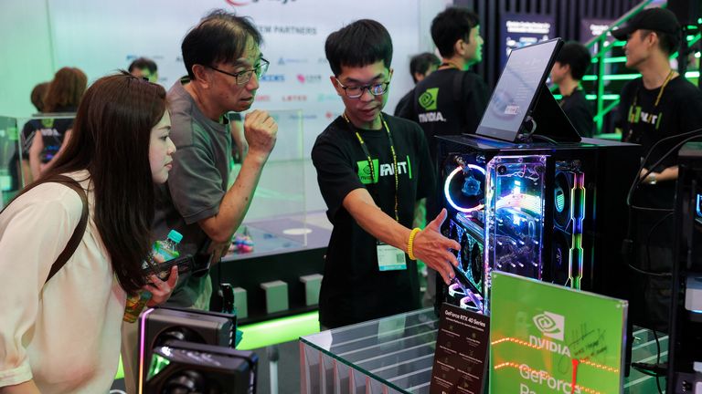 A staff introduce NVIDIA GeForce series equipment on display at Computex in Taipei, Taiwan June 5, 2024. REUTERS/Ann Wang