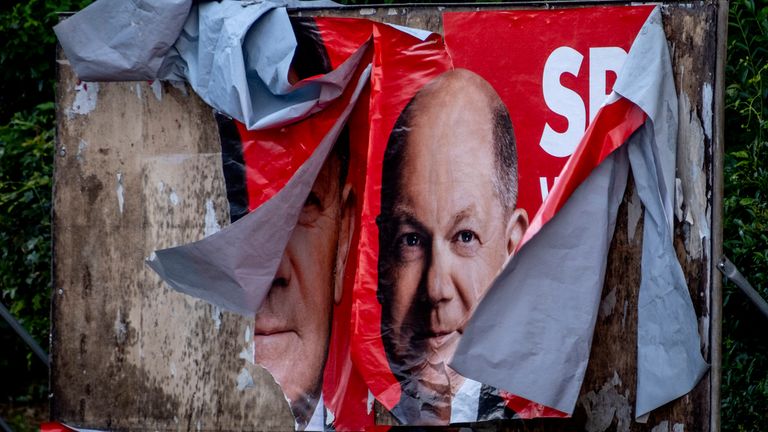 A damaged election poster shows German Chancellor Olaf Scholz in Frankfurt, Germany, Monday, June 10, 2024. (AP Photo/Michael Probst)