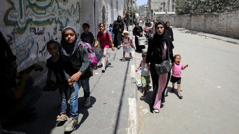Palestinians seen leaving the Shejaia neighbourhood following the attack. Pic: Reuters