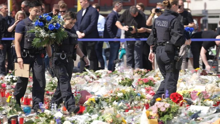 Colleagues lay flowers in Mannheim for police officer killed by a failed asylum seeker