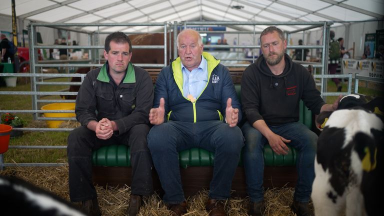 Dairy farmer Ray Brown (centre) with colleagues