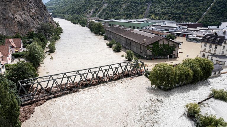 The River Rhone, right, and River Navizence overflowing in Chippis, Switzerland. Pic: Keystone via AP