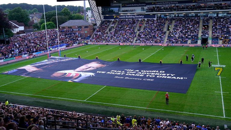 A general view of a large banner on the pitch in tribute to Rob Burrow before the Betfred Super League match at the AMT Stadium Headingley, Leeds.  Photo date: Friday, June 21, 2024. Photo: PA