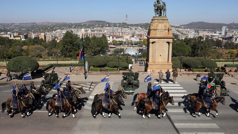 The South African Police Service (SAPS) equestrian unit arrives ahead of South Africa's Cyril Ramaphosa's motorcade 