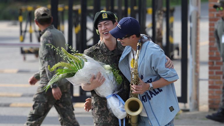 K-pop boy band BTS member Jin is greeted by a group member RM after being discharged from the military in Yeoncheon, South Korea.
Pic: Yonhap/Reuters