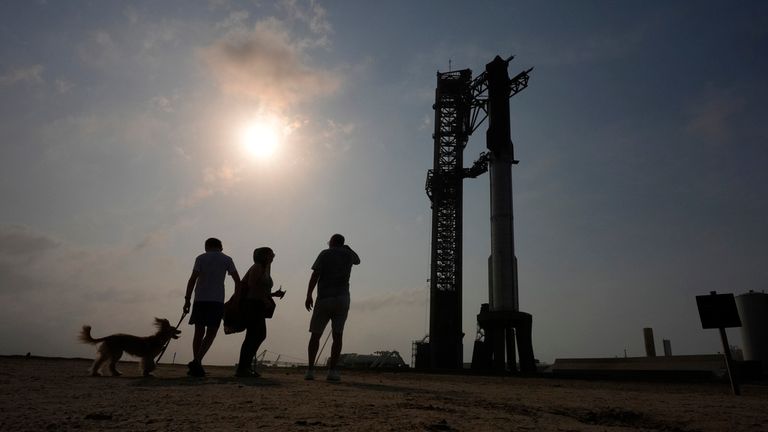 Onlookers watch as SpaceX&#39;s mega rocket Starship is prepared for a test flight from Starbase in Boca Chica, Texas, Wednesday, June 5, 2024. (AP Photo/Eric Gay)