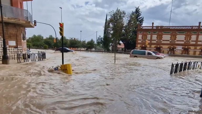 Drivers in Spain had to navigate roiling floodwaters on a roadway near the city of Murcia.