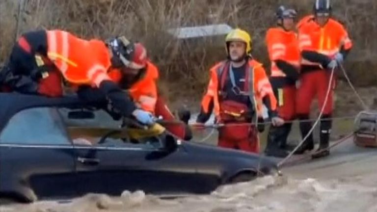 Spanish firefighters rescue person after car gets stuck in floods caused by heavy rain