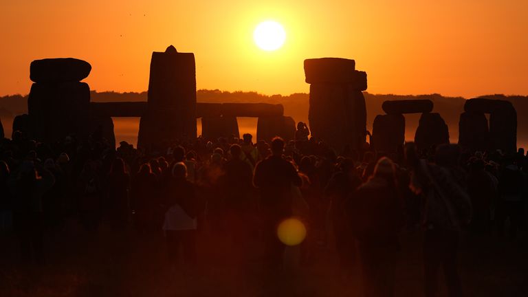 People watch the sun rise, as they take part in the Summer Solstice at Stonehenge.
Pic: PA
