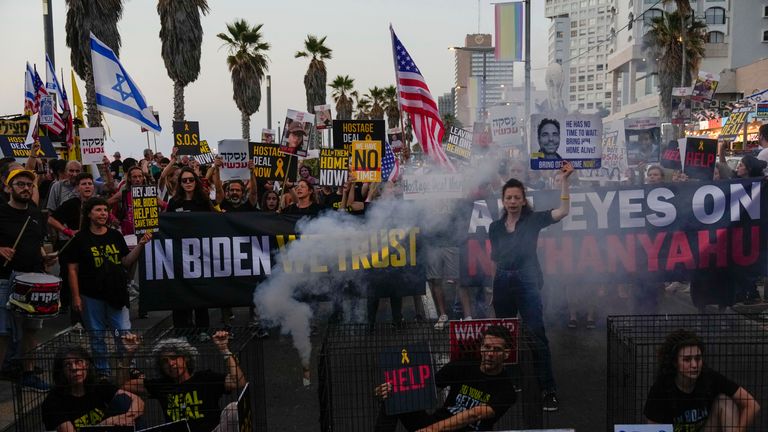 Demonstrators wave signs during a protest calling for the release of the hostages from Hamas captivity in the Gaza Strip, outside of the U.S. Embassy Branch Office in Tel Aviv, Israel, Monday, June 3, 2024. (AP Photo/Ariel Schalit)