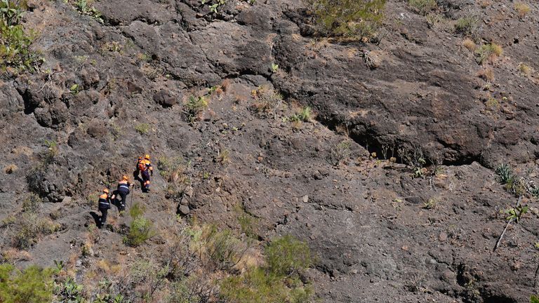 Emergency workers near the village of Masca, Tenerife.
Pic: PA
