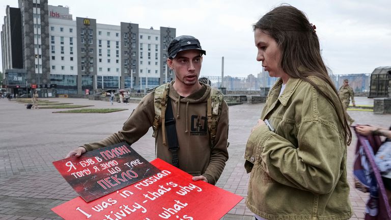 Svitlana Bilous and Illia Illiashenko, a Ukrainian former prisoner of war. Pic: Reuters