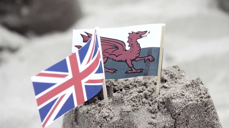 Wales and England flags in sandcastle