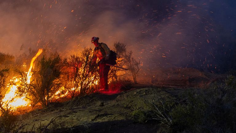 A firefighter tackles a wildfire in California. Pic: Reuters