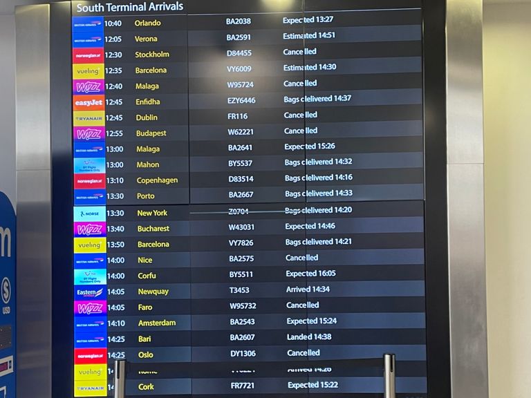 A board at Gatwick Airport shows a mix of fortunes for arriving passengers