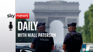 French police patrol on the Champs-Elysees avenue near the Arc de Triomphe ahead of the Olympics