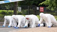 Forensic officers search near the scene at Sally Port in Gillingham,
