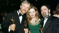 (L TO R:) Titanic director James Cameron, actress Kate Winslet and Titanic producer Jon Landau pose for pictures with their Oscars at the Governor's Ball following the 70th annual Academy Awards at the Shrine Auditorium in Los Angeles March 23. The film "Titanic" was nominated for 14 Academy Awards and won 11, tying the movie "Ben Hur" made in 1959.