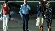 President Joe Biden talks on the phone as he walks to board Air Force One at McGuire Air Force Base, Saturday, June 29, 2024, in Burlington County, N.J. From left, Natalie Biden, Biden, Finnegan Biden, and first lady Jill Biden. (AP Photo/Evan Vucci)