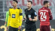 04 December 2021, North Rhine-Westphalia, Dortmund: 04.12.2021, North Rhine-Westphalia, Dortmund: Football, Bundesliga, Borussia Dortmund - FC Bayern Munich, Matchday 14 at Signal Iduna Park. Referee Felix Zwayer (M) walks past Dortmund's Jude Bellingham to the side of the pitch to watch the video evidence for the penalty kick that is subsequently given. Bayern's Corentin Tolisso is on the right. Photo by: Bernd Thissen/picture-alliance/dpa/AP Images


