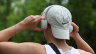 12 August 2023, Bavaria, W'rzburg: A young man puts on a pair of headphones. August 12 is International Youth Day. Photo by: Karl-Josef Hildenbrand/picture-alliance/dpa/AP Images