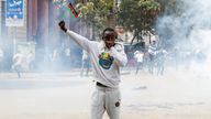 A man holds up a flag of Kenya as police use teargas to disperse protesters during a demonstration over police killings of people protesting against the imposition of tax hikes by the government in Nairobi, Kenya, July 2, 2024. REUTERS/Monicah Mwangi