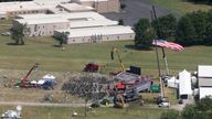 An aerial view shows the stage where Donald Trump was shot and a rooftop used by the gunman in the background. Pic: Reuters