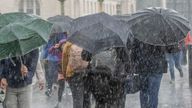 People run for cover from the heavy rain in Westminster in London . Picture date: Sunday July 7, 2024.

