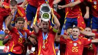 Spain's Alvaro Morata holds the trophy aloft