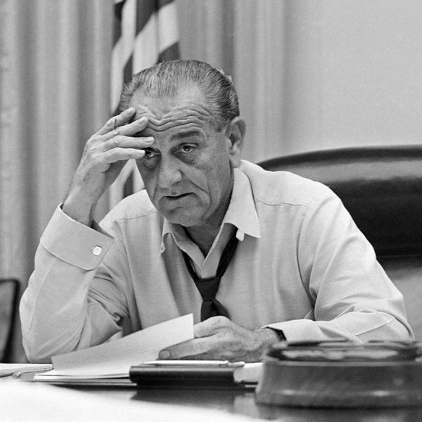 President Lyndon Johnson, in shirt sleeves and open collar, works on his speech in the White House Cabinet Room March 30, 1968. The following day the president announced to the nation that in order to devote himself to his duties, he would not seek or accept the nomination for re-election. (AP Photo/Bob Daugherty)