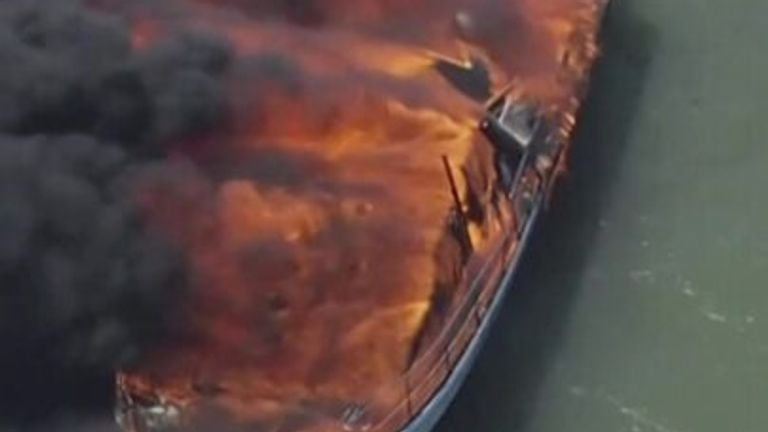 People jump overboard as boat catches fire
